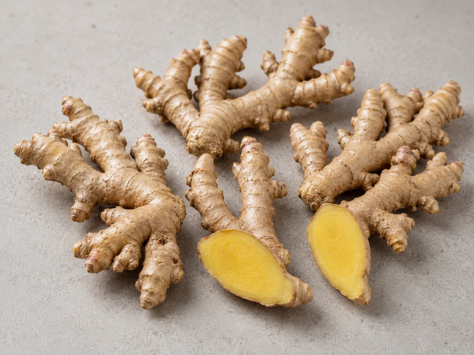 Fresh whole and cut ginger roots.